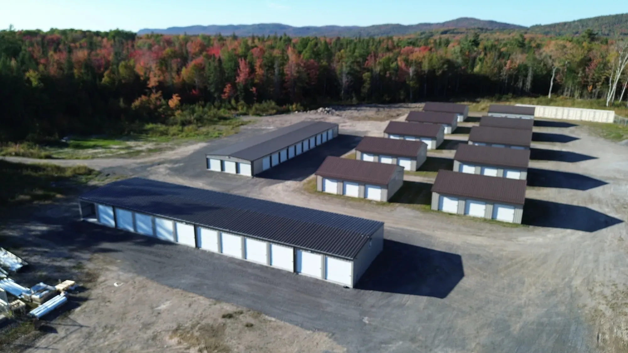 Storage buildings at Goulais Storage with fall foliage backdrop
