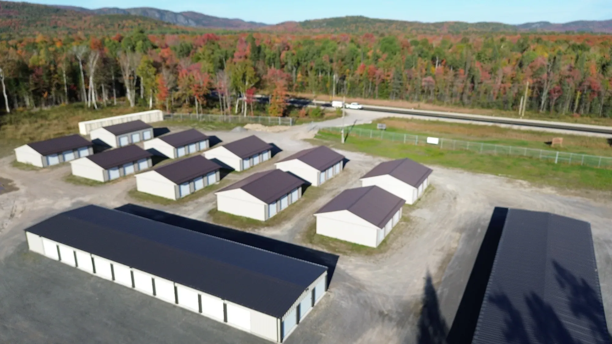 Multiple storage buildings at Goulais Storage with fall mountain backdrop